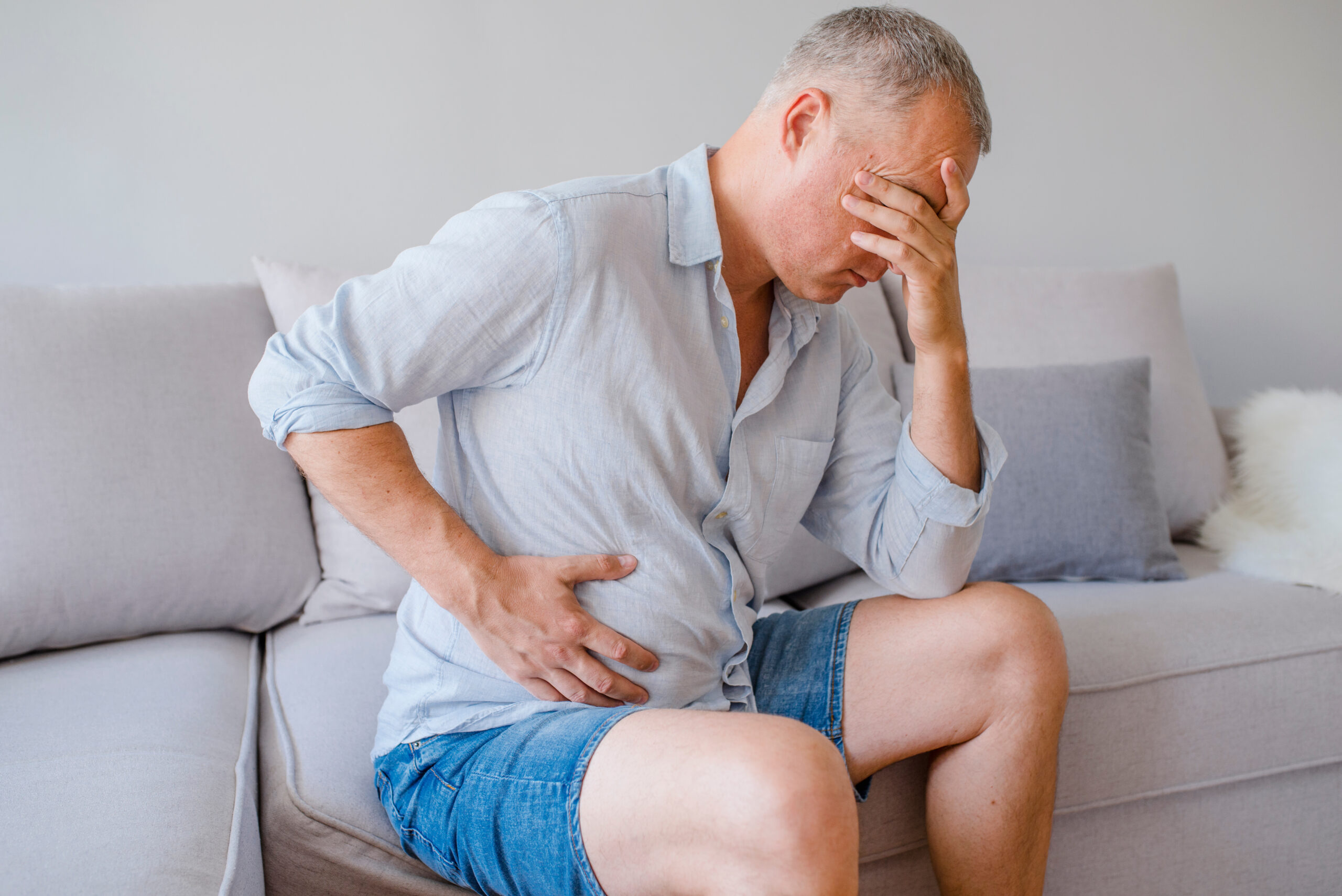 A middle-aged man has a stomach ache